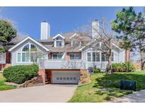 Charming two-story home featuring an attached two-car garage and a manicured front lawn at 3951 S Carson St # D, Aurora, CO 80014