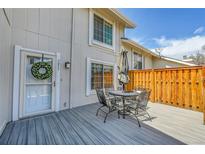 Charming back deck, perfect for outdoor dining and relaxation with patio furniture at 7077 S Knolls Way, Centennial, CO 80122