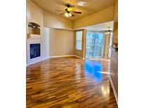 Bright living room featuring a fireplace, ceiling fan, and a sliding glass door at 4572 Copeland Loop # 203, Highlands Ranch, CO 80126