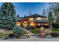 Charming two-story home with brick accents, a grand arched entryway, and manicured landscaping at 2464 Ginny Way, Lafayette, CO 80026