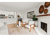 Bright living room with fireplace, hardwood floors, and stylish furniture at 14652 E 2Nd Ave # 202D, Aurora, CO 80011
