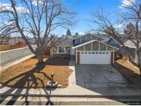 Charming two-story home with attached garage, mature trees, and well-maintained front yard at 3606 S Olathe Way, Aurora, CO 80013