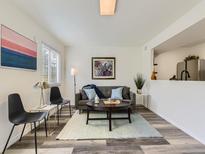 Comfortable living room with modern decor, gray sofa, and stylish coffee table at 12172 E Kepner Pl, Aurora, CO 80012