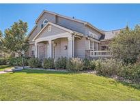 Charming home featuring a well-maintained lawn, lovely landscaping, and classic architectural details at 7380 E Lowry Blvd, Denver, CO 80230