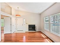 Bright living room with hardwood floors, fireplace, and large windows at 1829 S Union Blvd, Lakewood, CO 80228