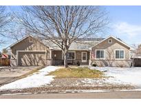 Charming single-story home with a well-maintained lawn, and a welcoming front porch at 7795 S Cody St, Littleton, CO 80128