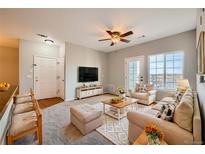 Comfortable living room with ceiling fan, plush seating, and a television for relaxation at 2705 S Danube Way # 306, Aurora, CO 80013