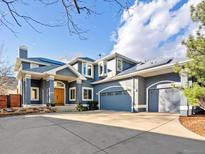 Inviting blue two-story home with a three car garage and large concrete driveway at 4825 6Th St, Boulder, CO 80304