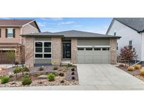 Charming single Gathering home with a beautifully landscaped front yard and attached two-car garage at 9130 Fraser River, Littleton, CO 80125