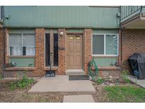 Inviting brick front entrance featuring a well maintained garden and visible address at 8870 W Jewell Ave # 11, Lakewood, CO 80232