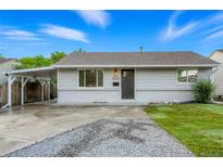 Charming single-story home with a cozy carport and manicured lawn at 5541 E 65Th Ave, Commerce City, CO 80022
