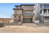A stylish two-story home with a stone facade and a spacious two-car garage, modern design at 2090 S Haleyville Way, Aurora, CO 80018