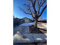 Charming single-story home with a convenient driveway and front yard at 389 Uvalda St, Aurora, CO 80011