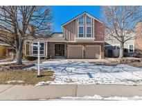 Two-story house with a brick facade, two-car garage, and a landscaped yard at 7757 S Nevada Dr, Littleton, CO 80120