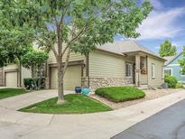 Charming single-Gathering home showcasing a well-manicured lawn and an attached two car garage at 4501 S Tabor Ct, Morrison, CO 80465