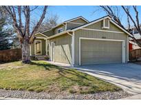 Charming single-Gathering home with a two-car garage and lovely green siding at 9519 Devon Ct, Highlands Ranch, CO 80126