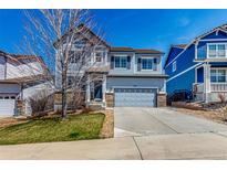 Charming two-story home with a well-maintained lawn and a two-car garage on a clear, sunny day at 2881 Black Canyon Way, Castle Rock, CO 80109