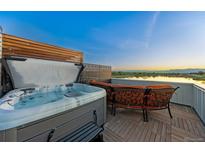 Rooftop deck featuring a hot tub and lounge area with expansive views of the surrounding landscape at 3101 W 47Th Ave # 13, Denver, CO 80211