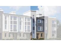 Modern three-story townhome featuring vertical siding and a brick facade at 14269 Currant St, Broomfield, CO 80020