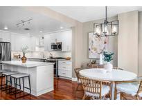 Bright eat-in kitchen with a large island and modern stainless steel appliances at 1631 N Emerson St # 117, Denver, CO 80218