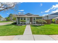 Charming single-story home with a well-manicured lawn and inviting stone accents near the entryway at 9901 E Evans Ave # 9A, Aurora, CO 80247