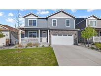 Charming two-story home with a well-maintained front lawn and covered porch at 2144 Rosette Ln, Castle Rock, CO 80104