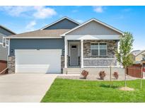 Charming single-Gathering home boasts a well-manicured lawn, stone accents, and an attached two-car garage at 4530 Cattle Cross Trl, Castle Rock, CO 80104