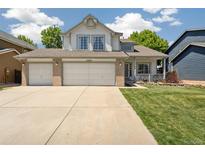 Charming two-story home with a three-car garage and a well-manicured lawn at 13439 Antlers St, Broomfield, CO 80020