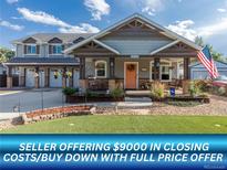 Charming home with a cozy front porch, landscaped yard, and well-maintained exterior at 10640 W 46Th Ave, Wheat Ridge, CO 80033