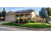Charming single-story home featuring a well-maintained front yard with lush grass and mature landscaping at 2190 S Uravan St, Aurora, CO 80013
