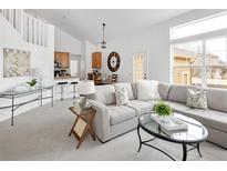 Bright open-concept living room with modern decor and large windows, perfect for entertaining or relaxing at 14214 Waterside Ln, Broomfield, CO 80023