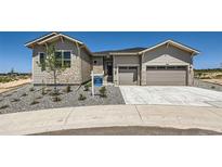 New construction home featuring a two-car garage and a stone-accented facade at 366 Agoseris Way, Castle Rock, CO 80104