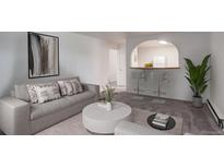 Bright living room boasts modern decor, comfortable seating, and stylish bar overlooking kitchen area at 2565 S Sheridan Blvd # 14, Lakewood, CO 80227
