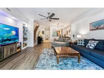 Cozy living room features a modern ceiling fan, comfortable seating, and hardwood flooring at 7250 Eastmoor Dr # 122, Denver, CO 80237