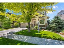 Charming home featuring a well-maintained lawn, lovely landscaping, and inviting curb appeal at 16404 E 117Th Ave, Commerce City, CO 80022