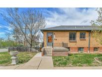 Charming brick home featuring a small front porch, well-maintained lawn, and inviting curb appeal at 1658 Winona Ct, Denver, CO 80204