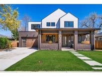 Charming two-story home with white siding, brick accents, covered porch, and well-maintained lawn at 2732 S Jackson St, Denver, CO 80210