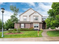 Charming two-story home featuring brick and siding, a manicured lawn, and mature trees at 2959 W 110Th Pl, Westminster, CO 80234