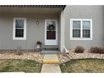 Charming entryway with wreath-adorned door, stone landscaping, and visible unit number at 2301 E Fremont Ave # W02, Centennial, CO 80122