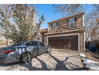 Two-story home features an attached garage and a well-maintained lawn at 2986 S Fundy Ct, Aurora, CO 80013