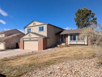 Charming two-story home with a well-maintained lawn and an attached two-car garage, perfect for suburban living at 805 Northridge Rd, Highlands Ranch, CO 80126