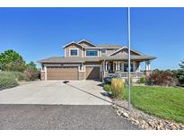 Charming two-story home with a manicured lawn, stone accents, and a welcoming front porch at 2351 Sagebrush St, Parker, CO 80138