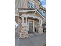 Charming stone-accented front entrance with a covered porch, offering curb appeal at 9771 Mayfair St # F, Englewood, CO 80112