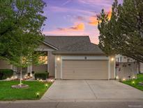 Charming single-Gathering home with well-maintained landscaping and attached two-car garage under a colorful sunset at 8240 Clayton Ct, Denver, CO 80229