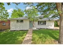 Charming single-story home features a well-manicured lawn and a welcoming walkway at 169 Yates St, Denver, CO 80219