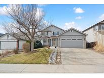 Charming two-story home with a well-manicured front yard and attached two-car garage at 13567 Cherry St, Thornton, CO 80241