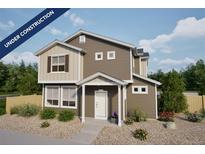 Charming two-story home with brown siding, white trim, and a well-manicured front yard. Under construction at 46509 Sunflower Ln, Bennett, CO 80102