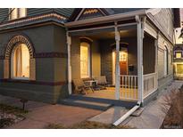 Inviting front porch featuring cozy seating, classic columns, and a warm, welcoming ambiance at 1433 Olive St, Denver, CO 80220