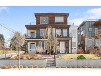 Modern two-story duplex featuring a brick facade, balconies, and manicured front yard at 2600 S Sherman St, Denver, CO 80210