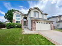 Inviting two-story home with a well-manicured lawn and a two-car garage in a residential neighborhood at 12566 Dexter St, Thornton, CO 80241